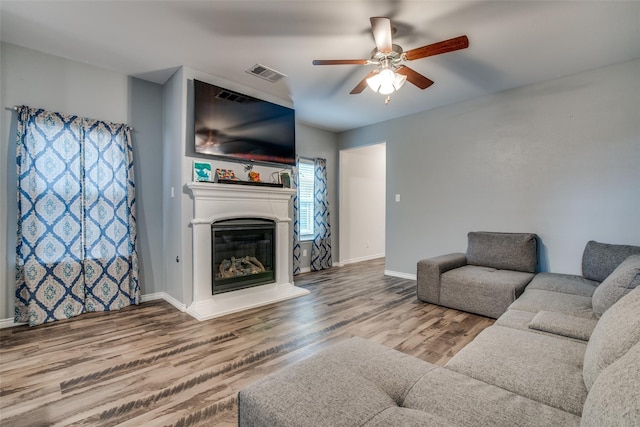living room with hardwood / wood-style floors and ceiling fan