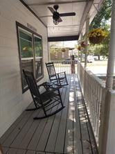 deck featuring a porch and ceiling fan