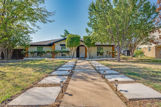 ranch-style home with a front yard