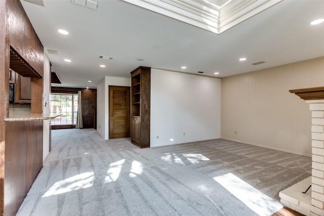 unfurnished living room with light colored carpet