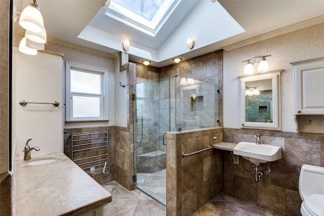 bathroom with sink, crown molding, tile walls, toilet, and walk in shower