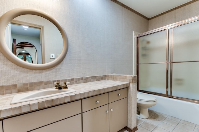 full bathroom with enclosed tub / shower combo, tile walls, vanity, ornamental molding, and tile patterned floors