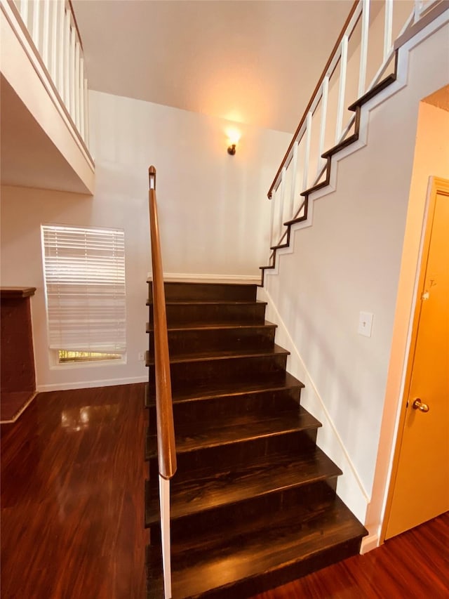 stairs with hardwood / wood-style floors