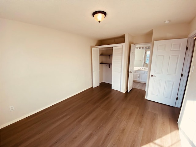 unfurnished bedroom featuring dark hardwood / wood-style floors and a closet