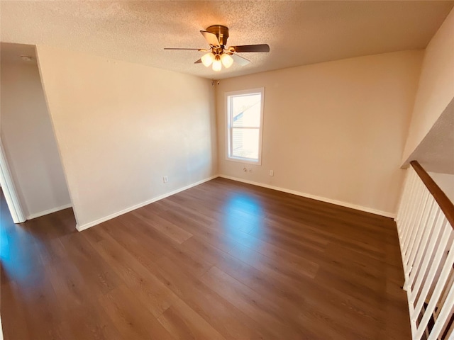 spare room with ceiling fan, dark hardwood / wood-style floors, and a textured ceiling