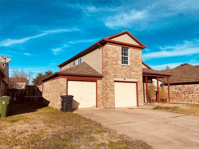 view of property exterior with a garage and a lawn