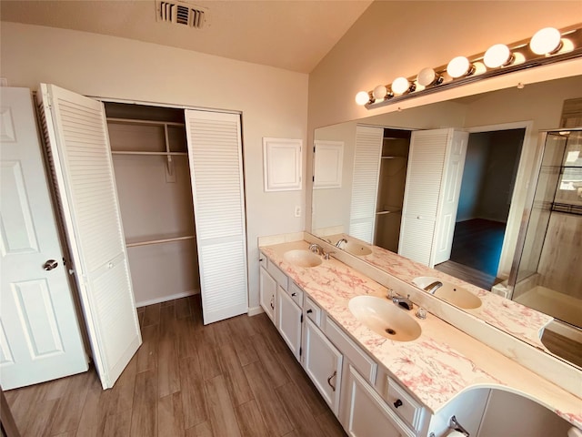 bathroom with vanity, an enclosed shower, and hardwood / wood-style floors