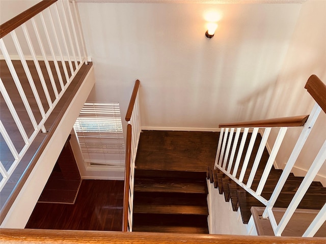 stairs featuring hardwood / wood-style flooring