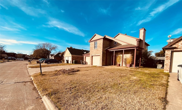 view of side of property with a garage and a lawn