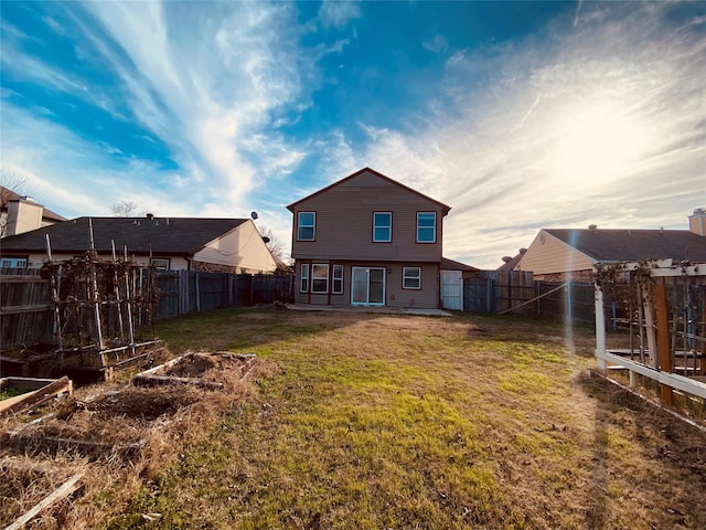 rear view of house featuring a lawn