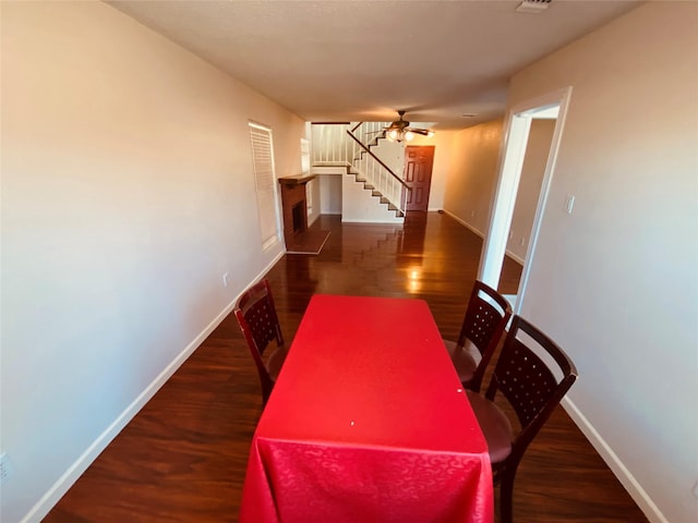 dining area with ceiling fan and dark hardwood / wood-style floors