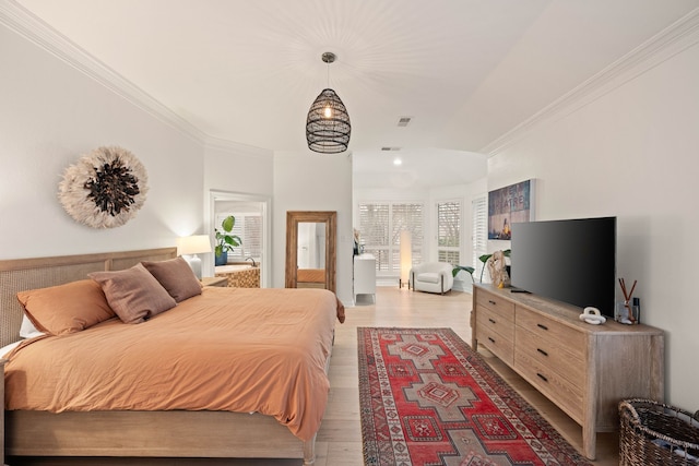 bedroom featuring crown molding and light hardwood / wood-style floors