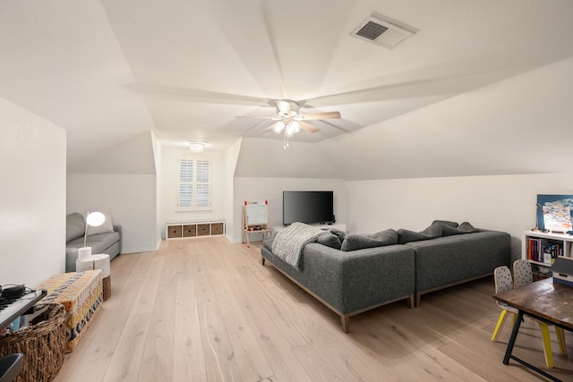 living room featuring lofted ceiling, ceiling fan, and light wood-type flooring