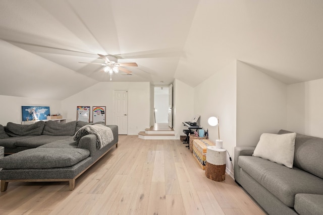 living room with vaulted ceiling and light hardwood / wood-style floors