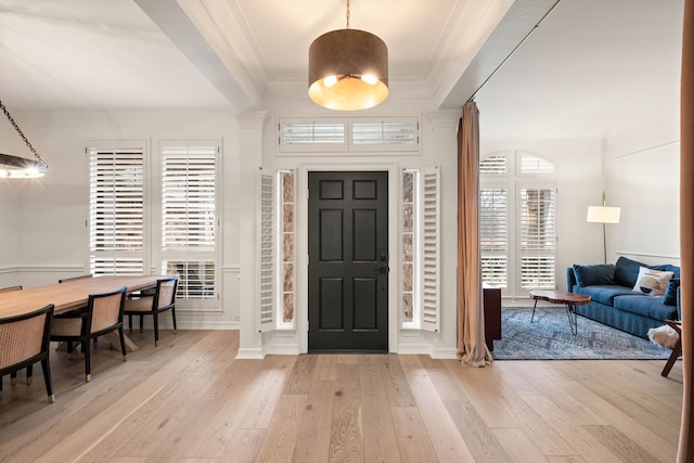 foyer featuring ornamental molding and light hardwood / wood-style floors