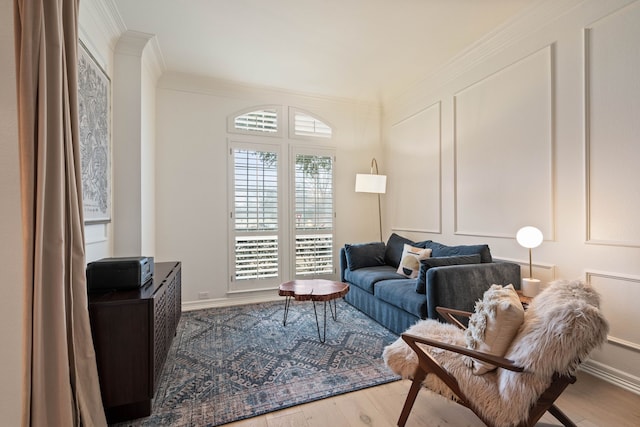 living room with crown molding and hardwood / wood-style flooring