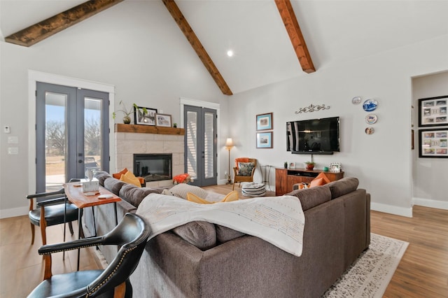 living room featuring beam ceiling, high vaulted ceiling, and french doors