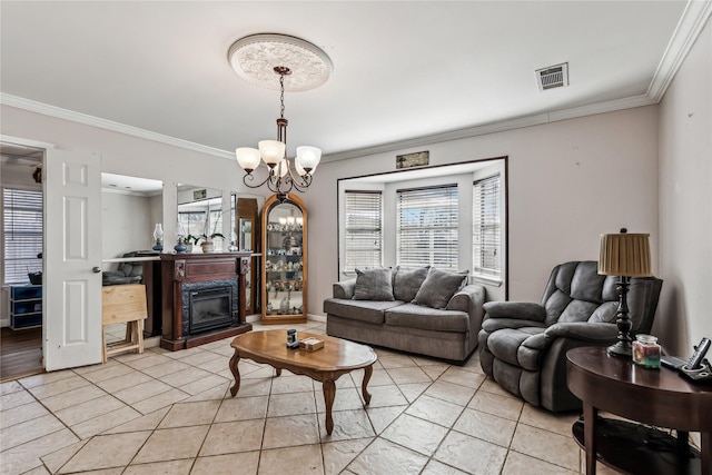 living area featuring light tile patterned floors, a notable chandelier, visible vents, a glass covered fireplace, and crown molding