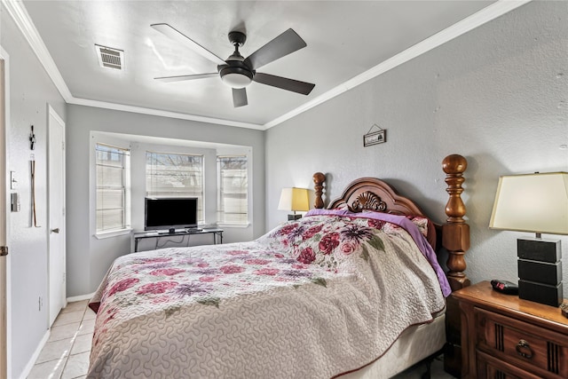 bedroom with tile patterned flooring, visible vents, baseboards, and ornamental molding