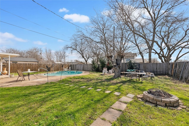 view of yard with a fenced in pool, a fenced backyard, and a fire pit