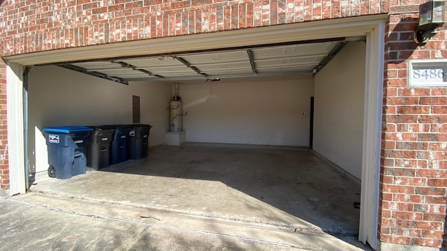 garage with strapped water heater and electric panel