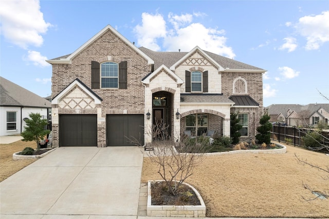 french country inspired facade featuring roof with shingles, brick siding, fence, a garage, and driveway