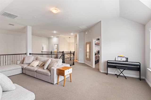 living room with visible vents, vaulted ceiling, light carpet, and baseboards