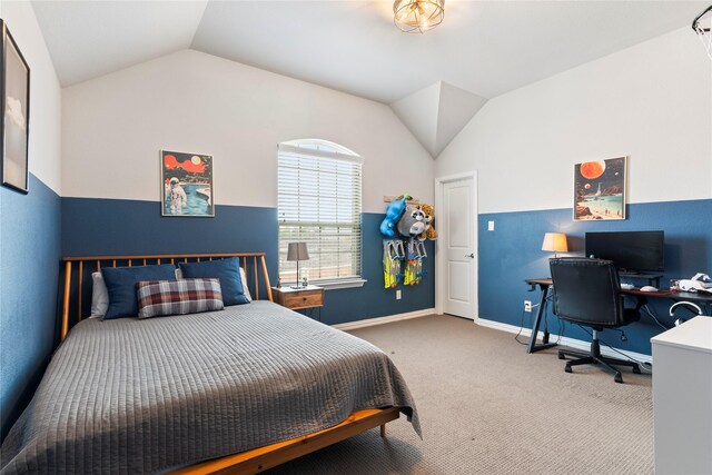 carpeted bedroom featuring lofted ceiling and baseboards