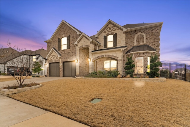 view of front of house with concrete driveway, brick siding, fence, and an attached garage