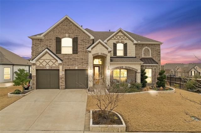 view of front of property with driveway, brick siding, a shingled roof, and fence