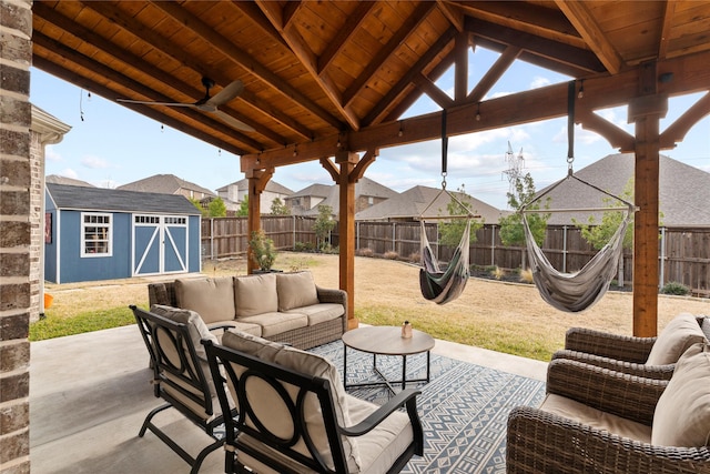 view of patio featuring ceiling fan, a storage shed, and outdoor lounge area