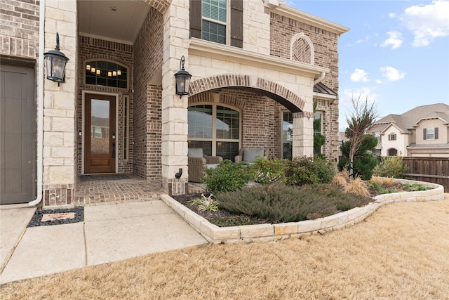 doorway to property featuring stone siding and brick siding