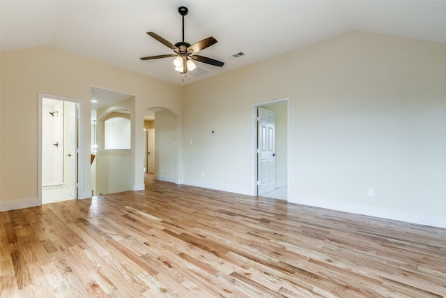 spare room featuring ceiling fan, lofted ceiling, and light wood-type flooring