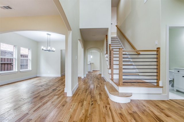 foyer entrance featuring an inviting chandelier and light wood-type flooring