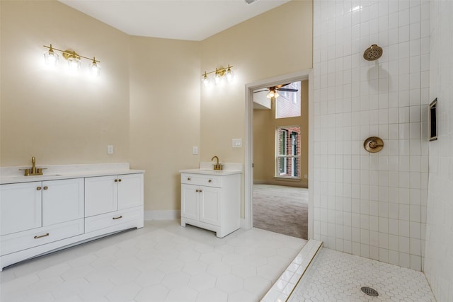 bathroom with ceiling fan, vanity, tile patterned flooring, and a tile shower