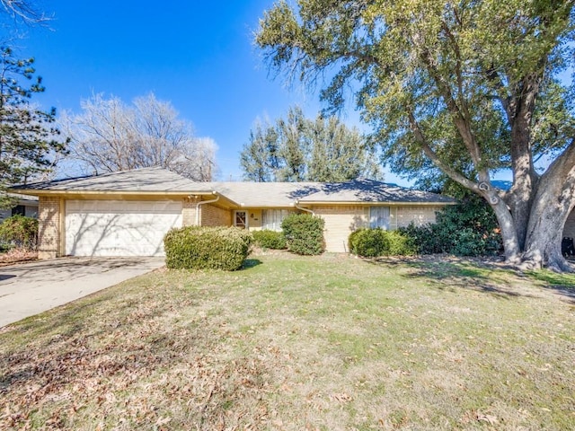 single story home featuring a garage and a front lawn