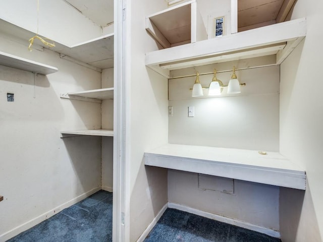 spacious closet featuring dark carpet