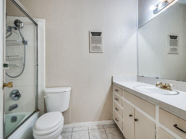 full bathroom featuring tile patterned flooring, vanity, shower / bath combination with glass door, and toilet