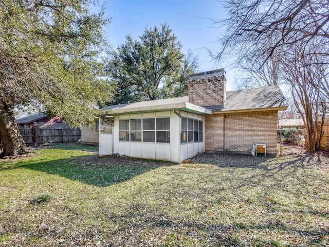 back of house with a yard, central AC unit, and a sunroom