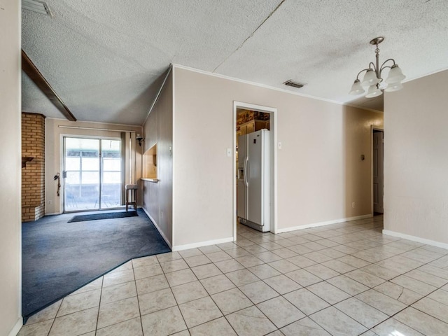 carpeted spare room with crown molding, a notable chandelier, and a textured ceiling