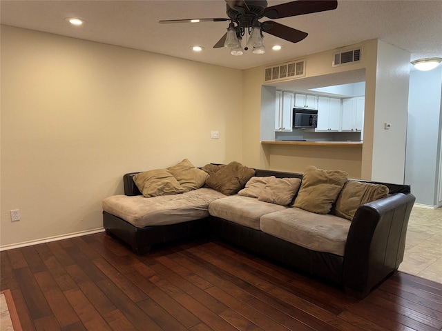 living room with hardwood / wood-style flooring and ceiling fan