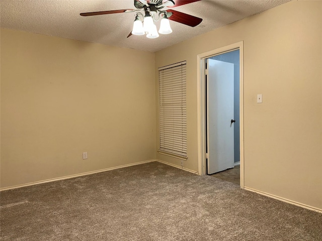 unfurnished bedroom featuring ceiling fan, dark carpet, and a textured ceiling