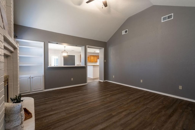 unfurnished living room featuring dark wood-type flooring, vaulted ceiling, and ceiling fan