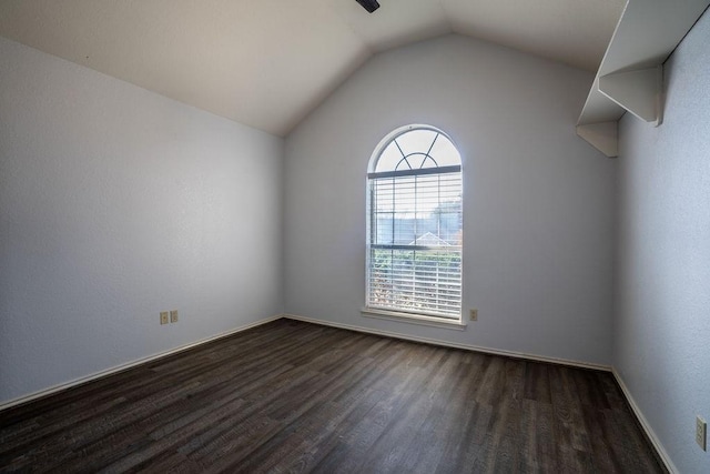 spare room with lofted ceiling and dark hardwood / wood-style floors