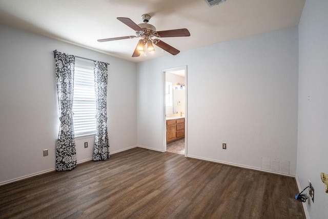 empty room featuring dark hardwood / wood-style flooring and ceiling fan