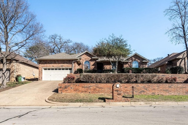 ranch-style house featuring a garage, brick siding, and driveway