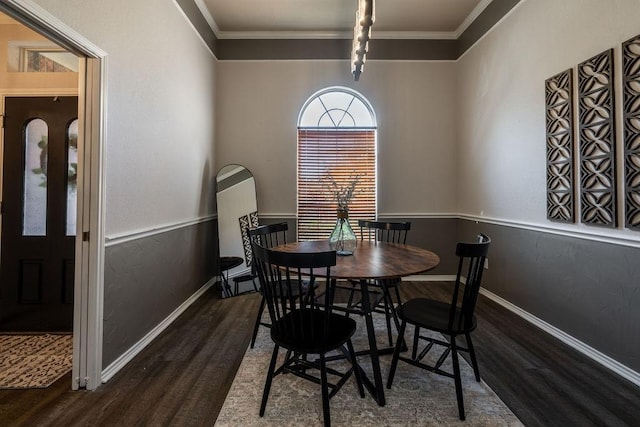 dining room with crown molding and dark hardwood / wood-style floors