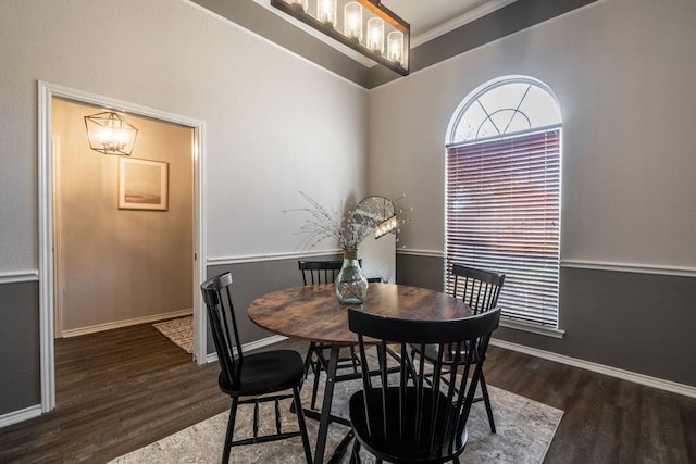 dining space featuring dark hardwood / wood-style flooring, ornamental molding, and a wealth of natural light