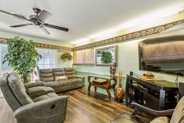 living room featuring hardwood / wood-style floors and ceiling fan