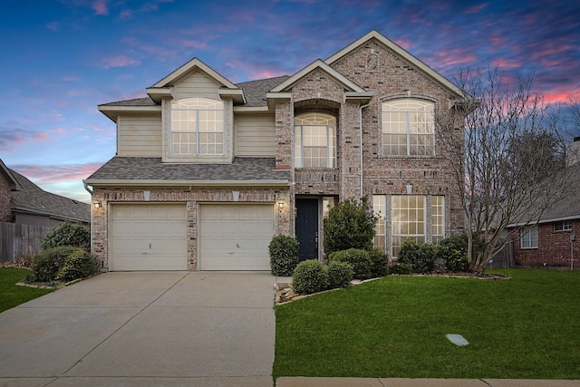 view of front of home with brick siding, a shingled roof, concrete driveway, a lawn, and an attached garage